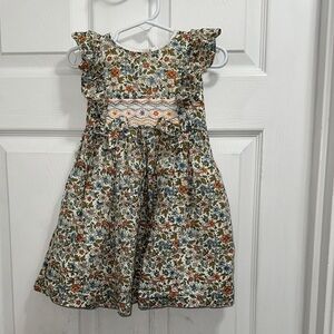 Bonnie Jean Cream Floral Smocked Ruffle Dress with Blue & Orange Accents